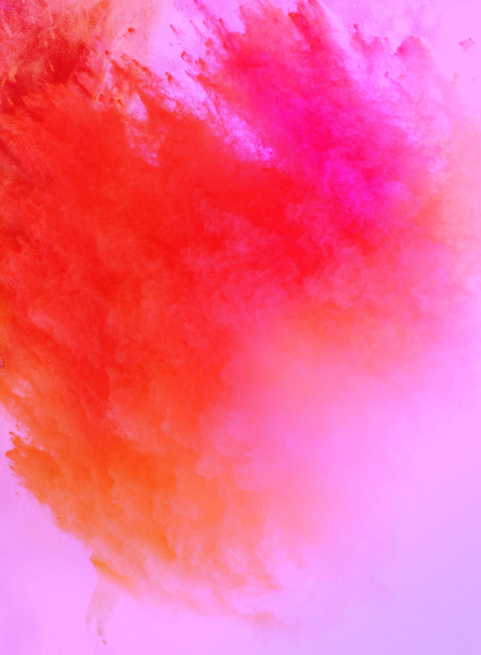 Powdered colors explode upwards in purples, oranges and pinks